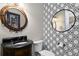 Stylish powder room with elegant fixtures, decorative mirrors, and patterned wallpaper for a modern touch at 2339 Lafayette Ave, Winter Park, FL 32789