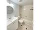 Bathroom featuring a bathtub, toilet, vanity with sink, round mirror, and neutral tones at 2468 Citrus Club Ln # 502, Orlando, FL 32839