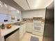 Efficient kitchen featuring white cabinetry, tiled backsplash, and a practical layout at 2468 Citrus Club Ln # 502, Orlando, FL 32839