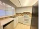 Efficient kitchen space featuring white cabinets, neutral countertops, and appliances for easy meal preparation at 2468 Citrus Club Ln # 502, Orlando, FL 32839