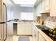 Efficient kitchen showcasing stainless steel appliances, tiled countertops and good lighting at 2468 Citrus Club Ln # 502, Orlando, FL 32839