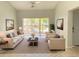 Bright living room featuring neutral furniture, sliding glass doors, and tile flooring at 2468 Citrus Club Ln # 502, Orlando, FL 32839