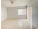Bright, open-concept living space featuring tiled floors, neutral walls, ceiling fan, and lots of natural light at 2468 Citrus Club Ln # 502, Orlando, FL 32839