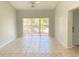 Bright, empty living room featuring neutral tile flooring and sliding glass doors at 2468 Citrus Club Ln # 502, Orlando, FL 32839