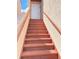Exterior stairway leading to unit's door with sturdy red handrails and neutral exterior paint at 2468 Citrus Club Ln # 502, Orlando, FL 32839