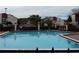 Community swimming pool surrounded by lush landscaping and lounge chairs on a sunny day at 2468 Citrus Club Ln # 502, Orlando, FL 32839