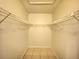Walk-in closet featuring built in shelving and tile flooring at 2468 Citrus Club Ln # 502, Orlando, FL 32839