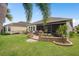 Well manicured backyard with lush lawn, privacy landscaping, and patio for entertaining at 2554 Stargrass Cir, Clermont, FL 34715