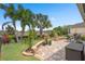 Backyard featuring lush landscaping, manicured lawn, and brick paver patio at 2554 Stargrass Cir, Clermont, FL 34715