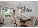 Inviting dining area featuring a wooden table, comfortable seating, and stylish decor and an open view to the lanai at 2554 Stargrass Cir, Clermont, FL 34715