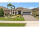Well-manicured front yard and landscaping compliment this home with a two-car garage at 2554 Stargrass Cir, Clermont, FL 34715