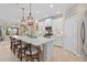 Bright kitchen featuring a large island with seating, pendant lighting, and modern stainless steel appliances at 2554 Stargrass Cir, Clermont, FL 34715