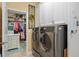 Laundry room features stainless steel machines and access to the walk-in closet at 2554 Stargrass Cir, Clermont, FL 34715