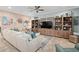 Inviting living room featuring a large sectional sofa, built-in shelving, and decorative accents at 2554 Stargrass Cir, Clermont, FL 34715