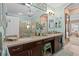 Bathroom with double vanity, decorative fixtures, and an open view to a walk-in shower at 2554 Stargrass Cir, Clermont, FL 34715