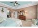 Bright main bedroom features wood furniture, carpet, and barn door access to the en suite bathroom at 2554 Stargrass Cir, Clermont, FL 34715