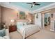 Spacious main bedroom boasts a decorative ceiling, carpet floors, and a barn door leading to the en suite bathroom at 2554 Stargrass Cir, Clermont, FL 34715