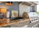 Granite counters and stacked stone accent the outdoor kitchen with stainless grill and sink at 2554 Stargrass Cir, Clermont, FL 34715