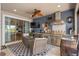 An outdoor kitchen with a grill and seating area provides an ideal place for entertaining at 2554 Stargrass Cir, Clermont, FL 34715