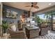 Inviting outdoor living space with covered seating, outdoor kitchen, and mounted television at 2554 Stargrass Cir, Clermont, FL 34715