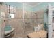 A shower with decorative tile and an adjacent bench seat offers comfort and style at 2554 Stargrass Cir, Clermont, FL 34715