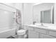 Clean bathroom featuring a bathtub with shower, white fixtures, and a minimalist design at 266 Marcello Blvd, Kissimmee, FL 34746