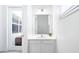 Bright bathroom featuring a single sink vanity, modern fixtures, and access to a patio at 266 Marcello Blvd, Kissimmee, FL 34746