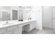 Elegant bathroom with double sinks, white cabinetry, and a spacious walk-in shower at 266 Marcello Blvd, Kissimmee, FL 34746