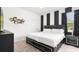 Stylish bedroom with a modern black and white theme, luxurious king bed, and decorative wall art for a sophisticated look at 266 Marcello Blvd, Kissimmee, FL 34746