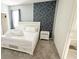 Inviting bedroom featuring a queen bed, ensuite bath, and modern accent wall with simple decor for easy personalization at 266 Marcello Blvd, Kissimmee, FL 34746