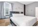 Modern bedroom featuring neutral tones, unique wall decor, and a large bed at 266 Marcello Blvd, Kissimmee, FL 34746