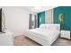 Bright bedroom with modern decor featuring a queen bed, TV, and stylish accent wall for a luxurious feel at 266 Marcello Blvd, Kissimmee, FL 34746