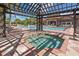 Relaxing hot tub beside the community pool featuring lounge chairs, pergolas and swaying palm trees at 266 Marcello Blvd, Kissimmee, FL 34746