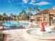 Resort-style pool area with a decorative fountain, lounge chairs and tropical palms under a bright blue sky at 266 Marcello Blvd, Kissimmee, FL 34746