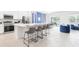 Modern kitchen features a sleek island with seating, stainless steel appliances, and ample counter space at 266 Marcello Blvd, Kissimmee, FL 34746