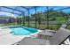 Relaxing screened-in pool and jacuzzi with lounge chairs for sunbathing and relaxation at 266 Marcello Blvd, Kissimmee, FL 34746