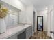 Bathroom with a vanity, large mirror, bathtub/shower, wood-look flooring and a full-length mirror at 2701 Sw 153Rd Ln, Ocala, FL 34473