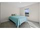 Bright bedroom boasts soft carpet, a cozy bed, and a sunlit window with pleasant outdoor views at 2701 Sw 153Rd Ln, Ocala, FL 34473