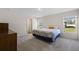 Sunlit bedroom features soft carpet, a comfortable bed, and bright windows with outdoor views at 2701 Sw 153Rd Ln, Ocala, FL 34473