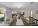 Bright dining area with long wooden table, flows seamlessly into the living room, perfect for entertaining at 2701 Sw 153Rd Ln, Ocala, FL 34473