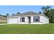 Charming single-story home with a well-manicured lawn, attached garage, and simple, modern design at 2701 Sw 153Rd Ln, Ocala, FL 34473