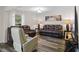 Cozy living room with comfortable leather seating, wood-look floors, and lots of natural light at 2701 Sw 153Rd Ln, Ocala, FL 34473