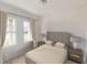 Cozy bedroom with natural light, two windows, neutral decor, and two nightstands at 3041 Daffodil Dr, Lake Hamilton, FL 33851