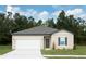 Charming single-story home with a gray roof, a two-car garage, and a well-manicured lawn at 3041 Daffodil Dr, Lake Hamilton, FL 33851