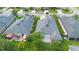 An aerial shot of a home's backyard with a patio, lush lawn, and mature landscaping, set in a quiet neighborhood at 305 Grande Lake Dr, Daytona Beach, FL 32124