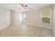 Bedroom with tile floor, ceiling fan, and two windows bringing in natural light at 305 Grande Lake Dr, Daytona Beach, FL 32124