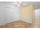 Cozy bedroom with a ceiling fan and double door closet at 305 Grande Lake Dr, Daytona Beach, FL 32124