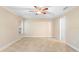 Bedroom featuring tile flooring, neutral walls, a ceiling fan and a window at 305 Grande Lake Dr, Daytona Beach, FL 32124