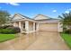 Charming single-story home featuring a well-manicured lawn and a two-car garage at 305 Grande Lake Dr, Daytona Beach, FL 32124