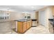 Kitchen with island featuring dark granite countertops, a dishwasher, and a sink at 305 Grande Lake Dr, Daytona Beach, FL 32124